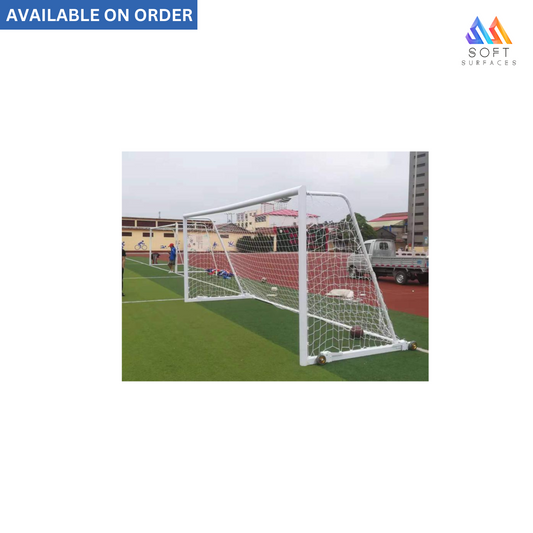 An 8' x 24' FIFA standard aluminum soccer goal with a white frame and a black and white net, set on a grass field.