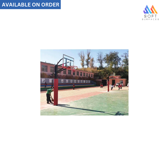 An outdoor basketball stand with a red post and backboard, adjustable height, installed in a playground setting.